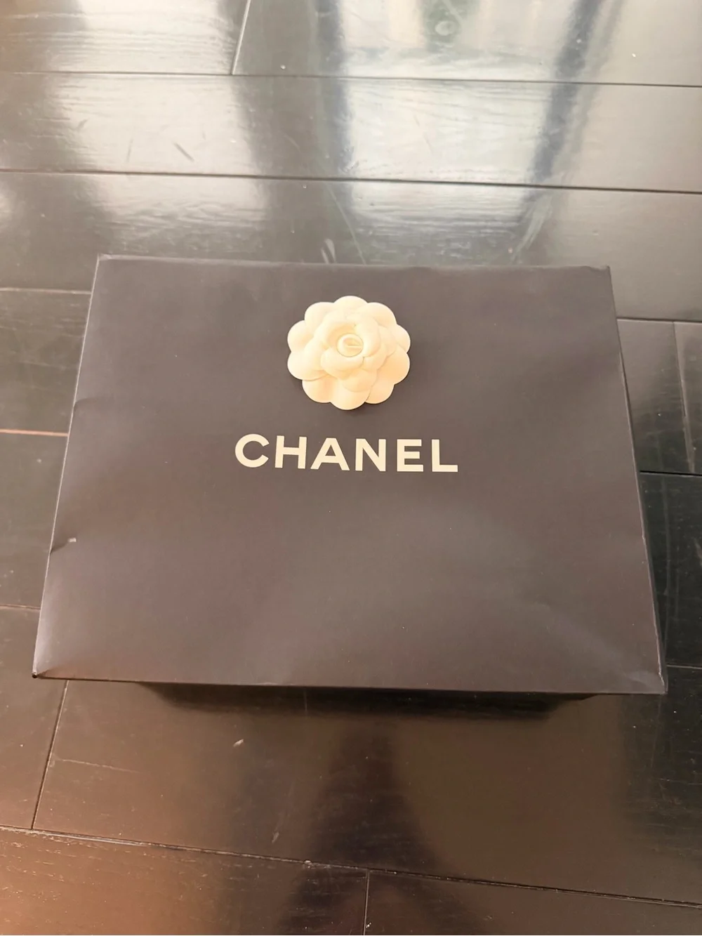 CHANEL Black bag (12” x 9”) with sticker flower accent
